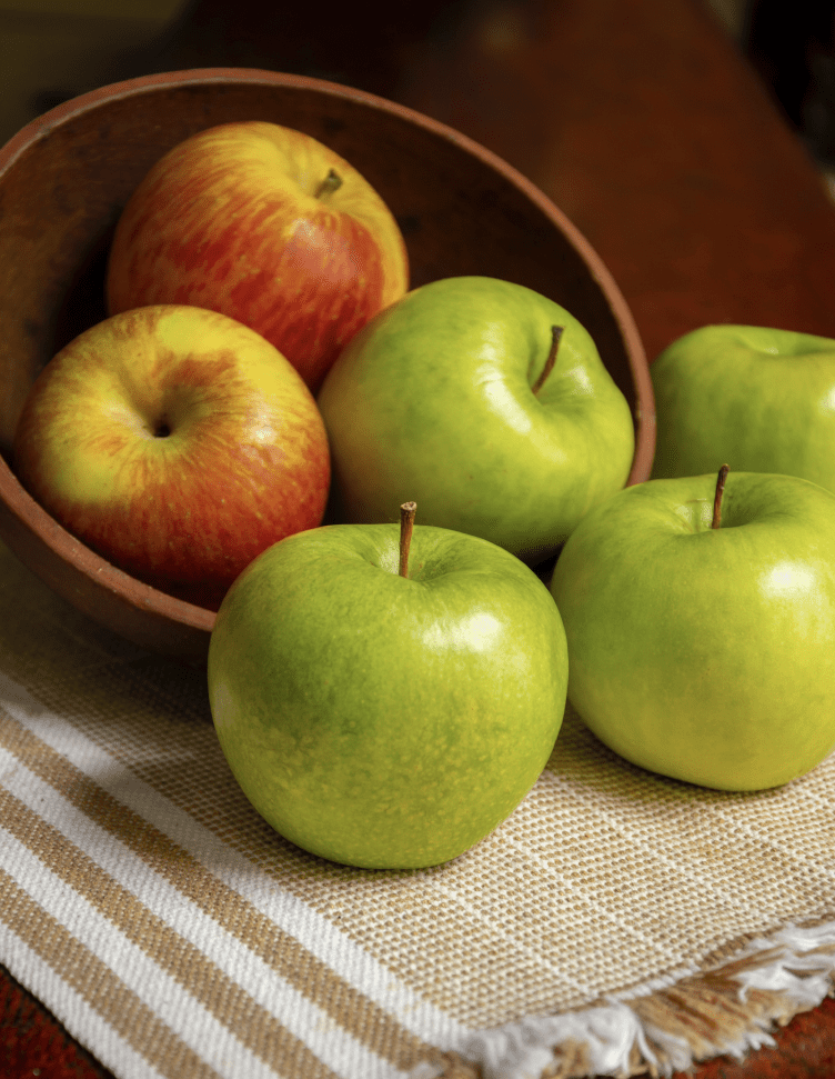 Green and red apples in a basket